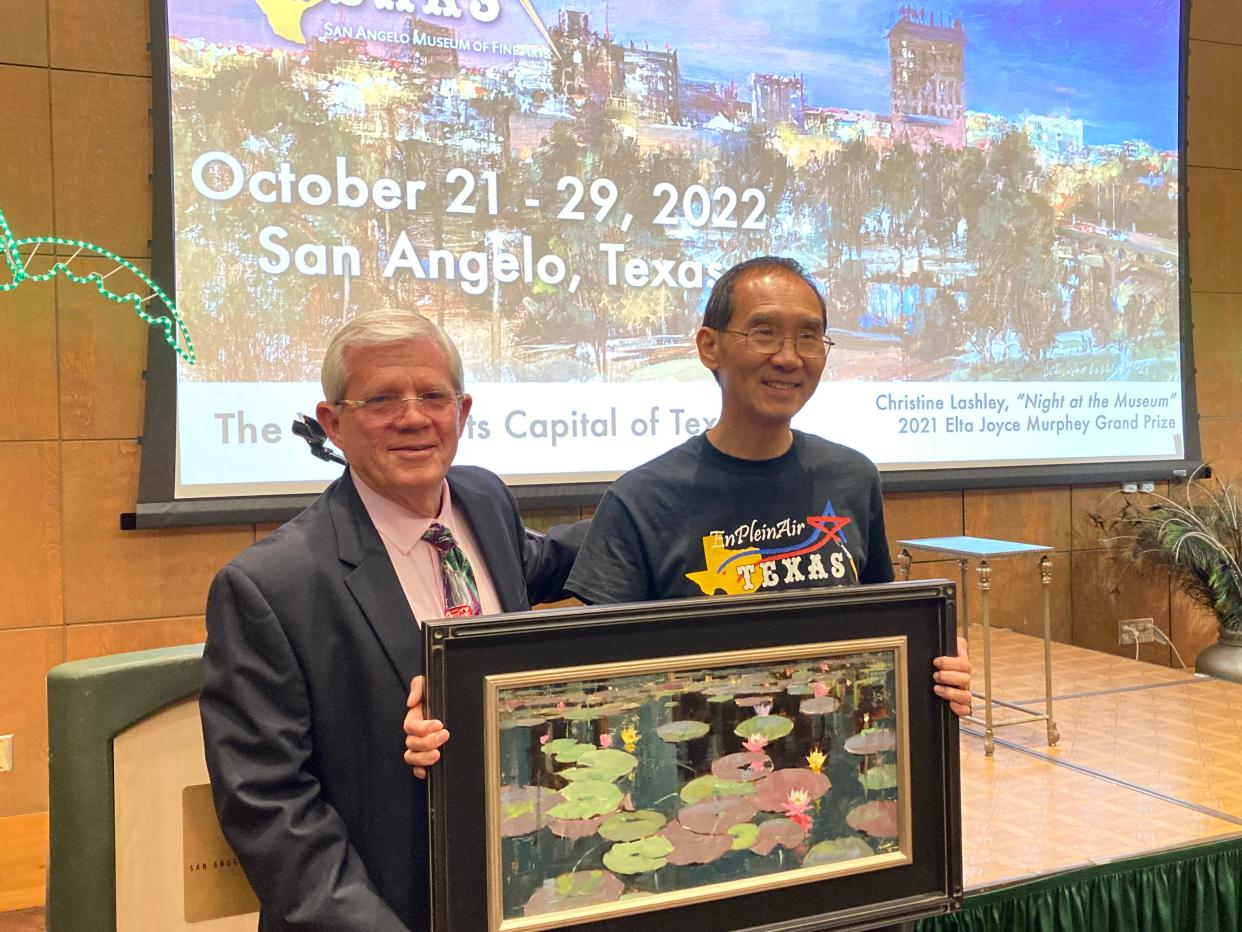 Steve Eustis, top bidder for the EnPleinAirTEXAS gala fundraiser Thursday, June 2, 2022, stands with artist Qiang Huang and his “Giverny in Texas” painting, which he painted live that evening.