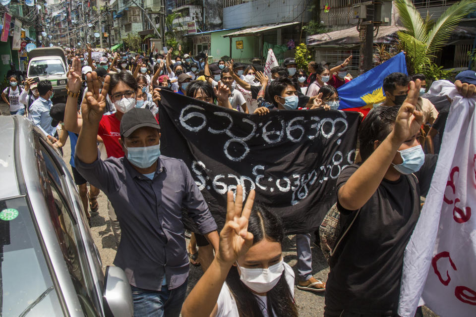 Anti-coup protesters flash the three-finger salute of defiance during a demonstration in Yangon, Myanmar on Tuesday April 27, 2021. Demonstrations have continued in many parts of the country since Saturday's meeting of leaders from the Association of Southeast Asian Nations, as have arrests and beatings by security forces despite an apparent agreement by junta leader Senior Gen. Min Aung Hlaing to end the violence. (AP Photo)