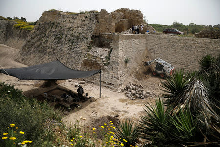 People work during an archaeological excavation at the foot of the Crusader wall in the old city of Caesarea, Israel. April 26, 2017 REUTERS/Amir Cohen