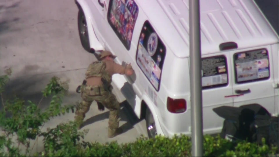 Authorities are seen in Plantation, Florida taking a man into custody in connection to the mailed package bombs.