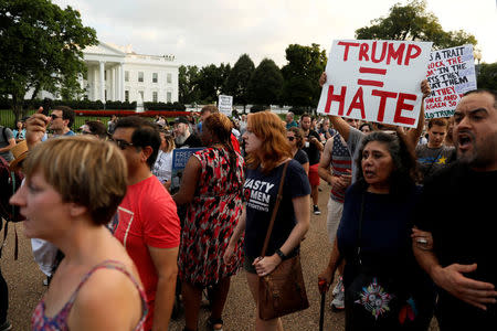 FILE PHOTO: People gather for a vigil in response to the death of a counter-demonstrator at the "Unite the Right" rally in Charlottesville, outside the White House in Washington, DC, U.S. on August 13, 2017. REUTERS/Jonathan Ernst/File Photo