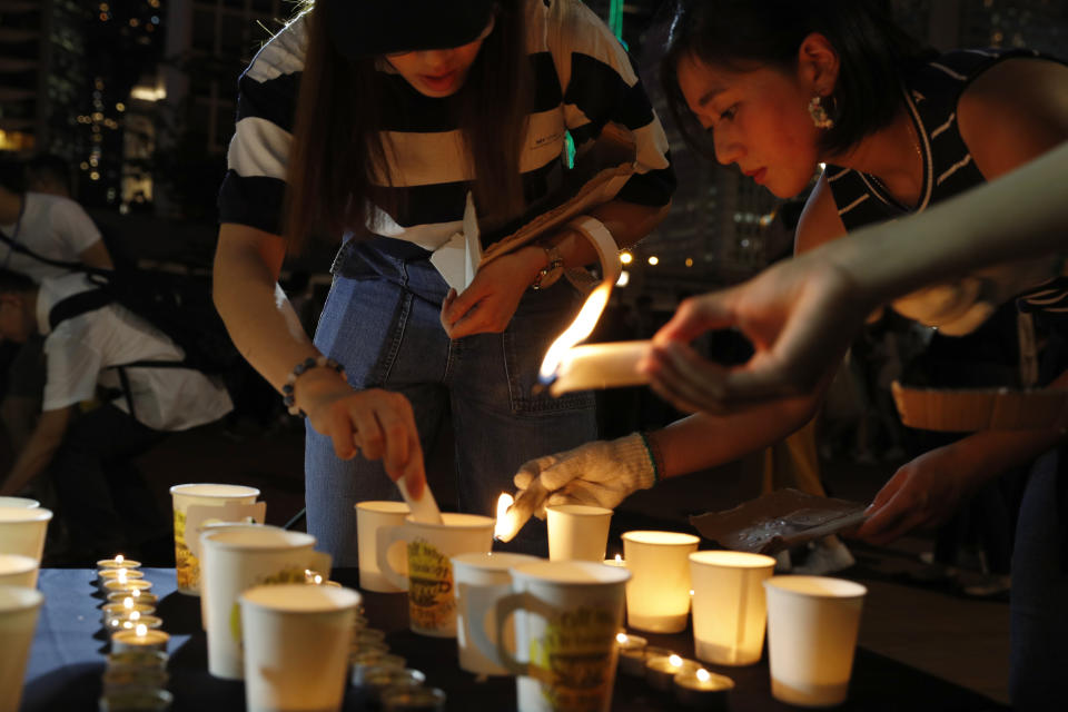 Protesters join a candle light vigil for the fourth apparent suicide related to the protests against an extradition law to China in Hong Kong on Wednesday, July 10, 2019. It's still the world's "freest" economy, one of the biggest global financial centers and a scenic haven for tycoons and tourists, but the waves of protests rocking Hong Kong are exposing strains unlikely to dissipate as communist-ruled Beijing's influence grows.(AP Photo/Vincent Yu)