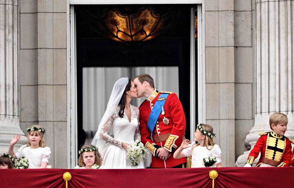 Prince William kisses his bride Duchess Kate of Cambridge on the balcony of Buckingham Palace, after their wedding at Westminster Abbey on April 29, 2011.