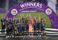 Lyon players celebrate with trophy after winning the Women's Champions League final soccer match between Wolfsburg and Lyon at the Anoeta stadium in San Sebastian, Spain, Sunday, Aug. 30, 2020. Lyon won the match 1-3. (Villar Lopez/Pool via AP)