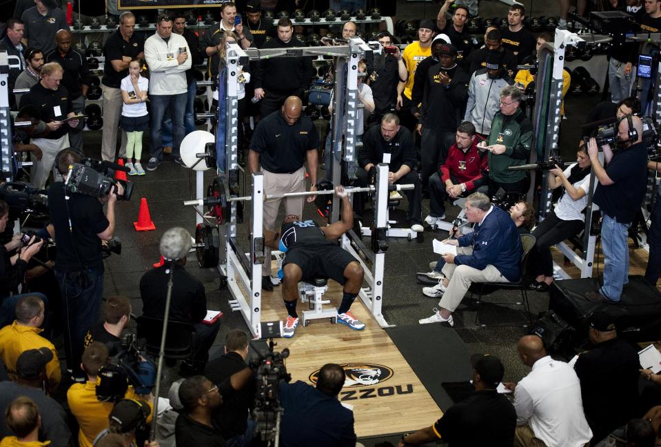 Scouts, teammates and media gather to watch former Missouri defensive lineman Michael Sam perform the bench press during pro day for NFL football representatives Thursday, March 20, 2014, in Columbia, Mo. (AP Photo/L.G. Patterson)