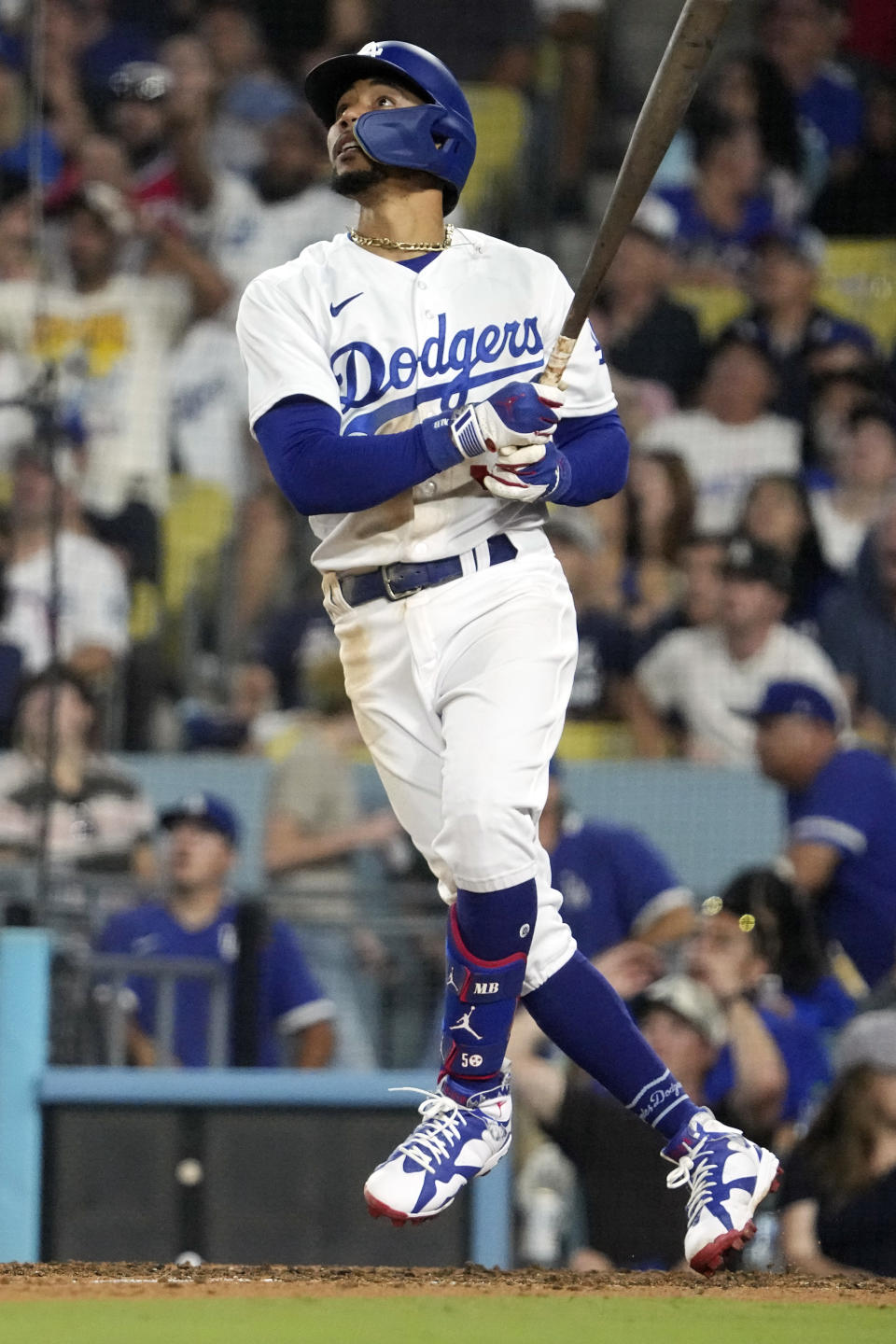 Los Angeles Dodgers' Mookie Betts watches the ball goes out for a solo home run during the seventh inning of a baseball game against the Atlanta Braves Thursday, Aug. 31, 2023, in Los Angeles. (AP Photo/Mark J. Terrill)