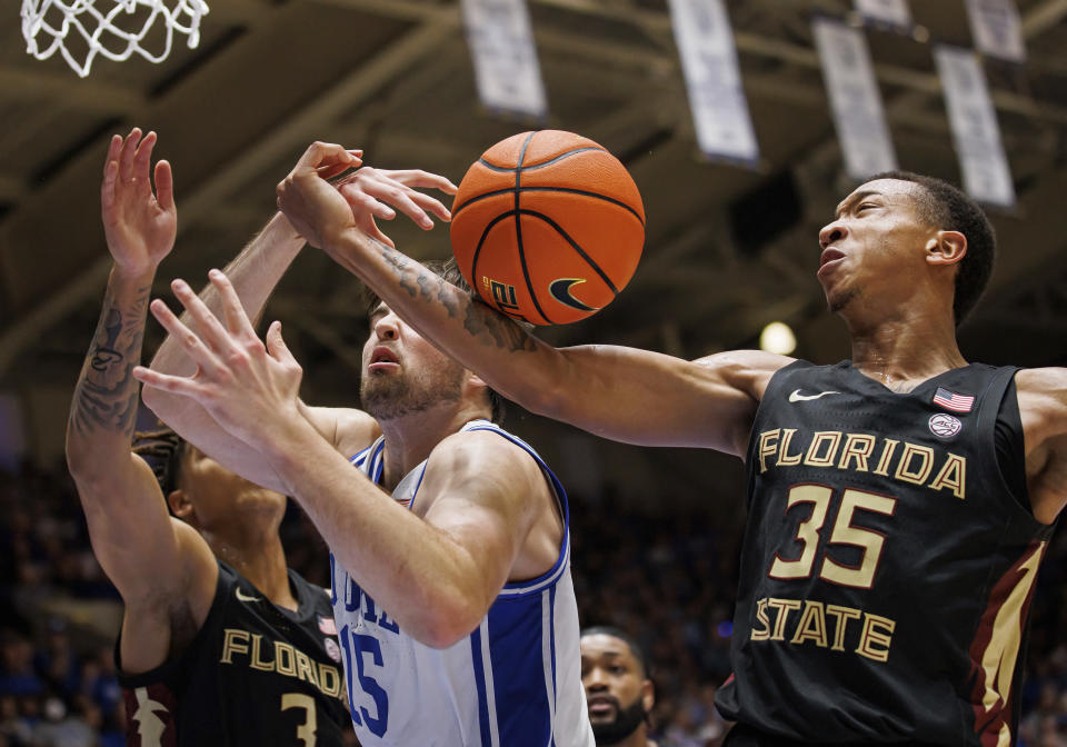 Florida State's Matthew Cleveland (35) and Cam Corhen (3) battle for a rebound with Duke's Ryan Young (15) during the second half of an NCAA college basketball game in Durham, N.C., Saturday, Dec. 31, 2022. (AP Photo/Ben McKeown)