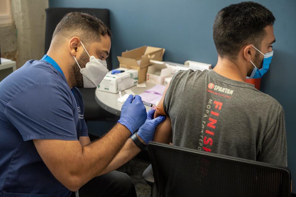 Nurse Ismael De Olveira administers a monkeypox vaccine at the JRI Health state backed monkeypox vaccination site in Framingham, July 25, 2022.