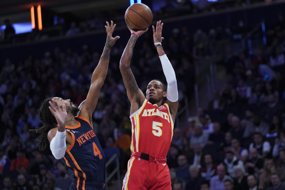 Atlanta Hawks guard Dejounte Murray (5) shoots as New York Knicks guard Derrick Rose (4) defends during the first half of an NBA basketball game Wednesday, Nov. 2, 2022, at Madison Square Garden in New York. (AP Photo/Mary Altaffer)