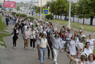 Belarusian women rally in solidarity with protesters injured in the latest rallies against the results of the country's presidential election in Minsk, Belarus, Thursday, Aug. 13, 2020. Hundreds of people were back on the streets of Belarus' capital on Thursday morning, forming long "lines of solidarity" in protest against an election they say was rigged to extend the rule of the country's authoritarian leader and against a crackdown on rallies that followed the vote. (AP Photo/Sergei Grits)
