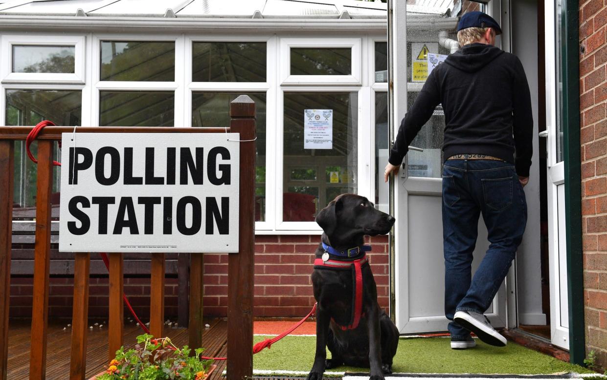 A voter enters a polling station in Stalybridge, Cheshire