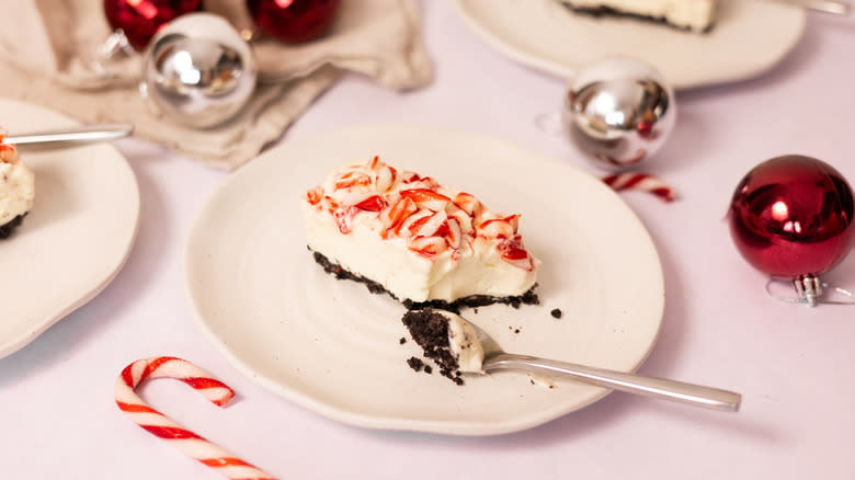 white chocolate candy cane cheesecake bars on plate 
