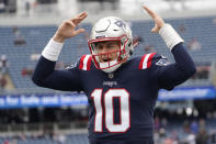 New England Patriots quarterback Mac Jones yells as he runs down the sidelines prior to an NFL football game, Sunday, Nov. 28, 2021, in Foxborough, Mass. (AP Photo/Mary Schwalm)