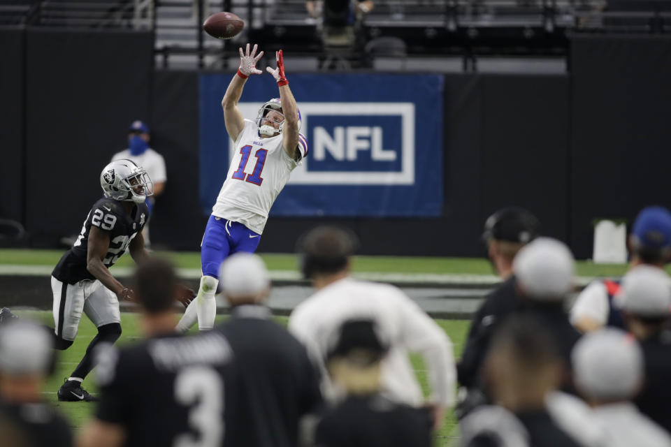Buffalo Bills wide receiver Cole Beasley (11) reaches up for a pass over Las Vegas Raiders free safety Lamarcus Joyner (29) during the second half of an NFL football game, Sunday, Oct. 4, 2020, in Las Vegas. (AP Photo/Isaac Brekken)