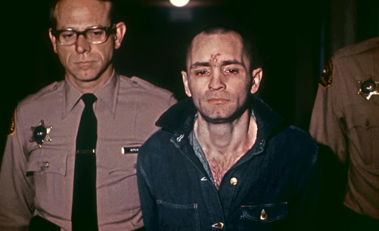 Sullen-faced Charles Manson is escorted to hear his death sentence, passed by the court, in Los Angeles, on March 29, 1971