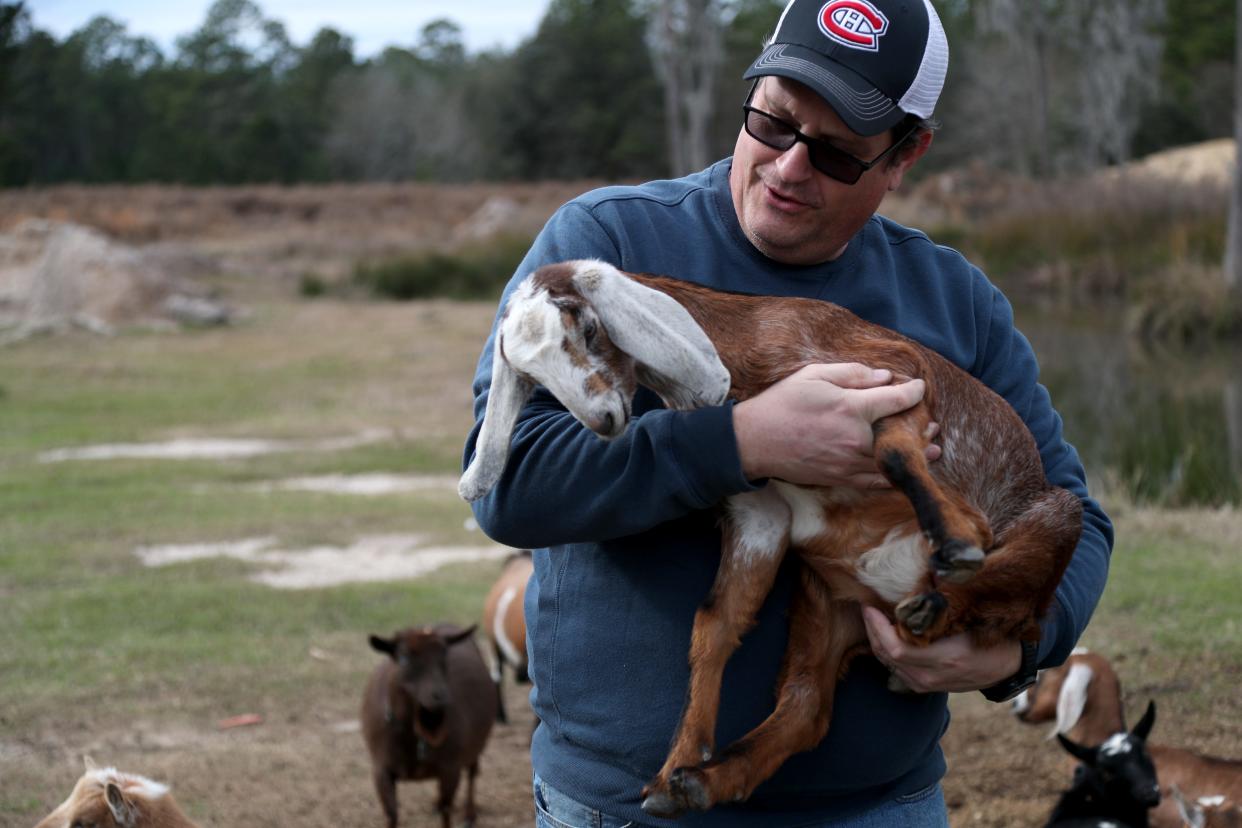 Robert Lodge holds a kid at his farm near Pembroke, Georgia farm where he raises and trains goats.