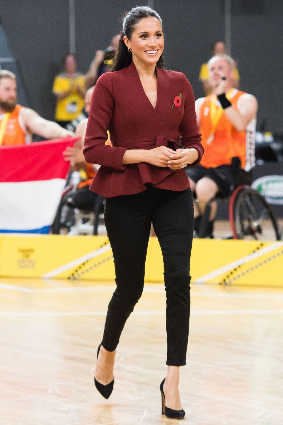 <p><strong>October 2018 </strong>The Duchess of Sussex attended the Wheelchair Basketball final at the Invictus Games in a Scanlan Theodore wrap top and fitted trousers.</p>