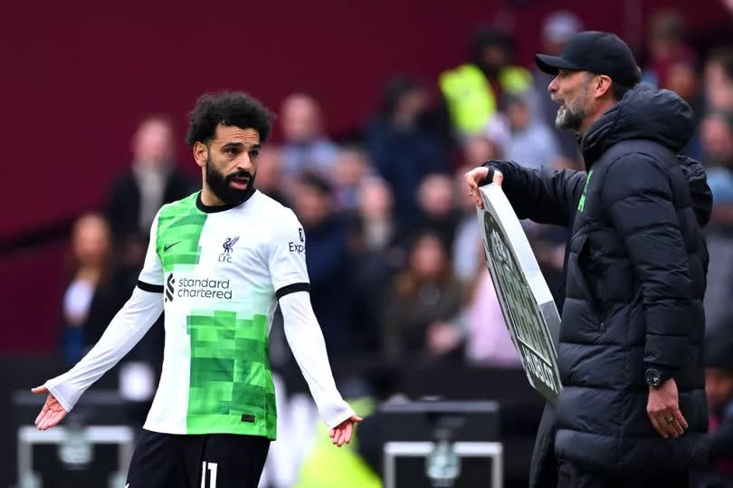 Mohamed Salah of Liverpool clashes with Jurgen Klopp, Manager of Liverpool, during the Premier League match between West Ham United and Liverpool FC at London Stadium on April 27, 2024 in London, England