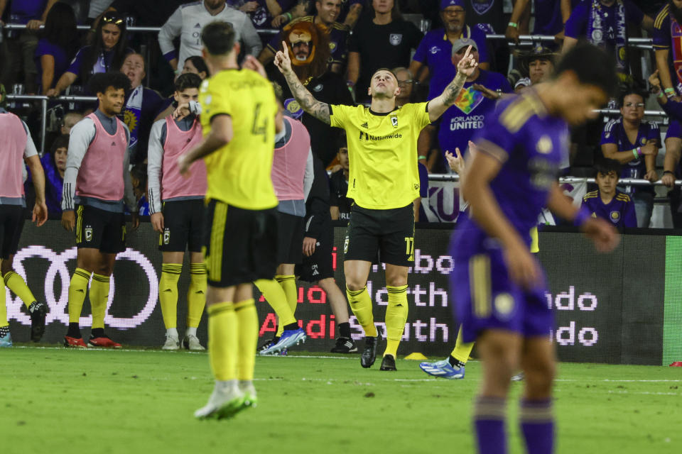 Columbus Crew forward Christian Ramirez, middle, celebrates after scoring a goal against Orlando City during over-time of an MLS soccer playoff match, Saturday, Nov. 25, 2023, in Orlando, Fla. (AP Photo/Kevin Kolczynski)