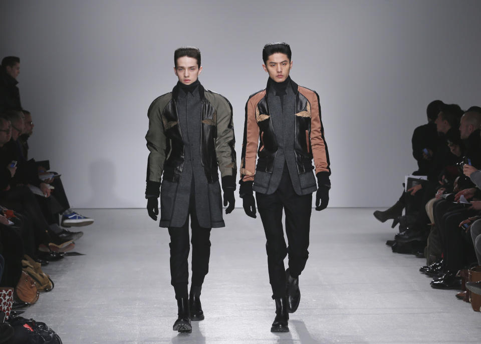 Models wear creations by South Korean fashion designer Juun. J as part of his presentation for Men's 2013 fall-winter 2013/2014 men's fashion collection, presented in Paris, Friday, Jan.18, 2013. (AP Photo/Jacques Brinon)