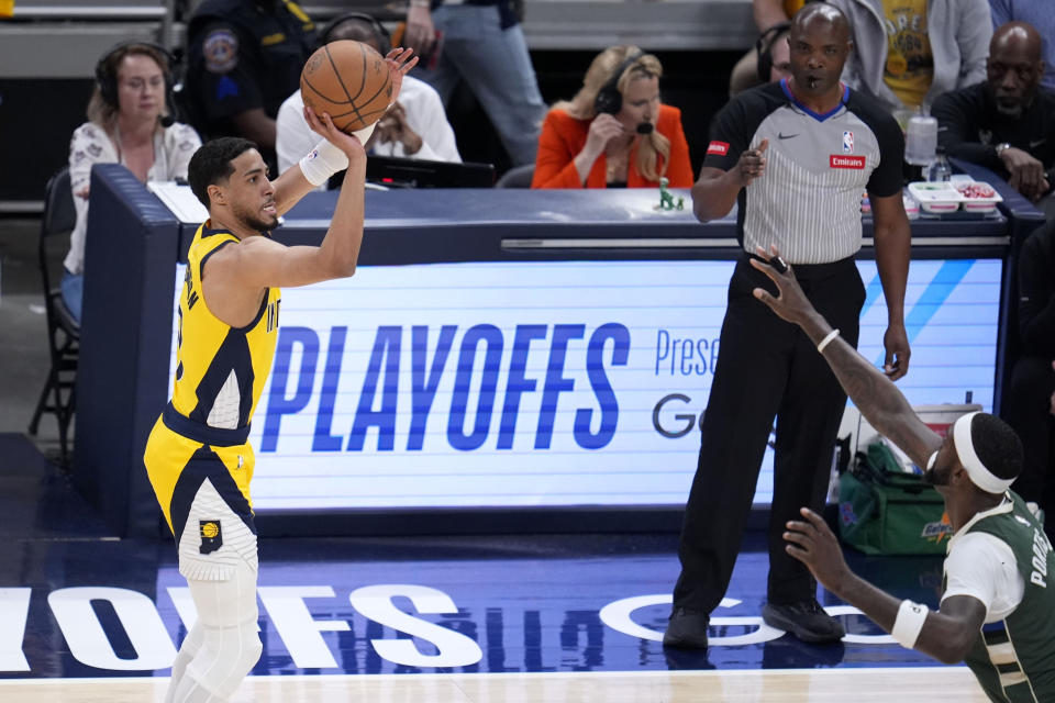 Indiana Pacers guard Tyrese Haliburton, left, shoots over Milwaukee Bucks forward Bobby Portis during the first half in Game 6 in an NBA basketball first-round playoff series, Thursday, May 2, 2024, in Indianapolis. (AP Photo/Michael Conroy)