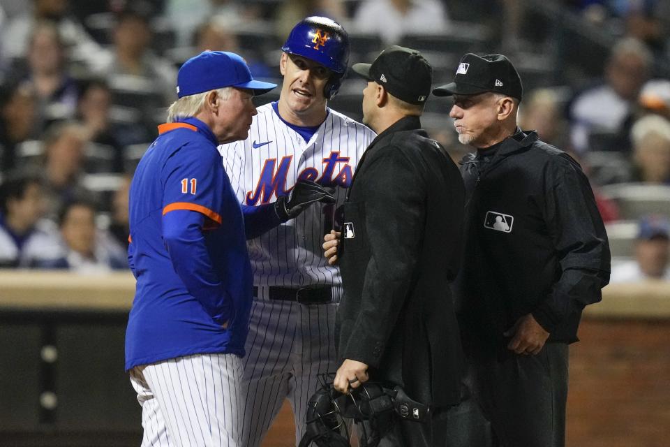 New York Mets manager Buck Showalter, left, and Mets' Mark Canha, second from left, argue a call with home plate umpire Will Little, second from right, and third base umpire Lance Barksdale during the ninth inning of the team's baseball game against the San Diego Padres on Tuesday, April 11, 2023, in New York. (AP Photo/Frank Franklin II)
