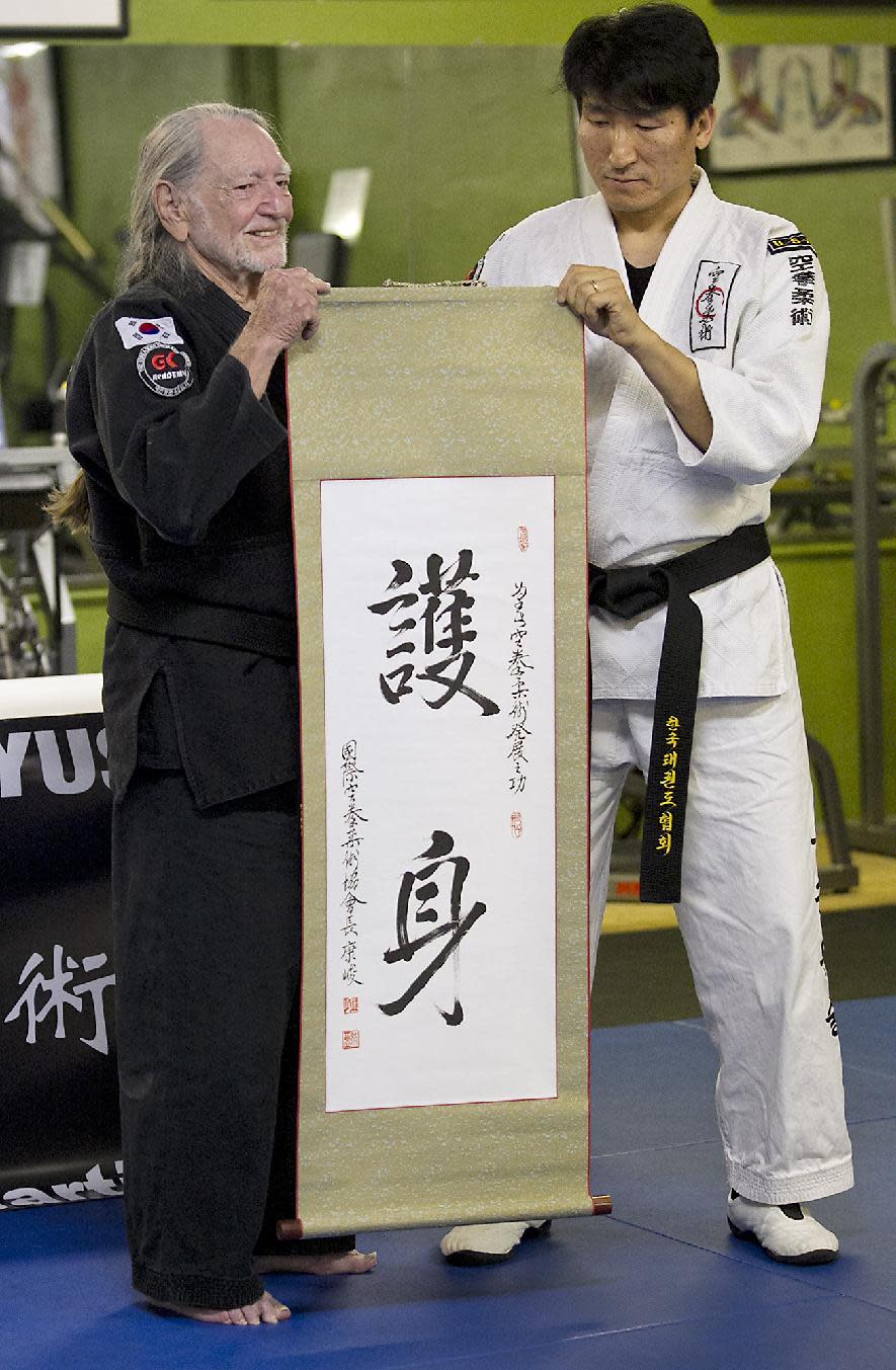 Willie Nelson, the country music icon who turns 81 this week, receives his fifth-degree black belt in the martial art of Gong Kwon Yu Sul on Monday, April 28, 2014, in Austin, Texas. (AP Photo/Austin American-Statesman, Ralph Barrera) AUSTIN CHRONICLE OUT, COMMUNITY IMPACT OUT, INTERNET AND TV MUST CREDIT PHOTOGRAPHER AND STATESMAN.COM, MAGS OUT