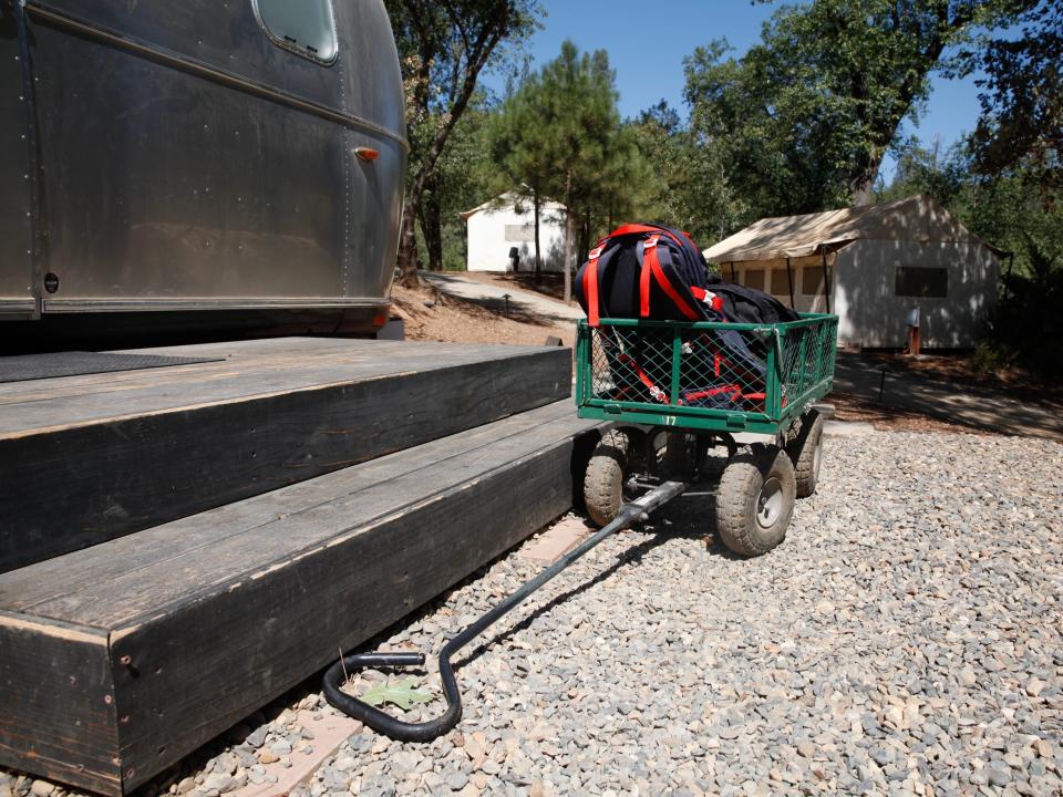 A wagon with my overnight bags besides stairs