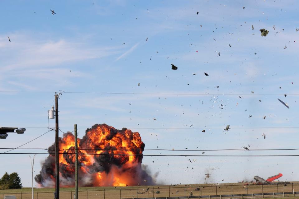 In this photo provided by Nathaniel Ross Photography, a historic military plane crashes after colliding with another plane during an airshow at Dallas Executive Airport in Dallas on Saturday, Nov. 12, 2022. (AP)