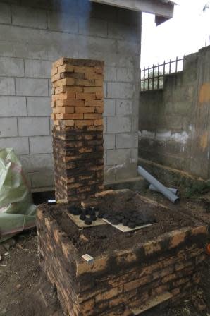 Our completed (for now) kiln. We are using the excess heat from the kiln to dry some briquettes which you can see sitting on the roof of the kiln.