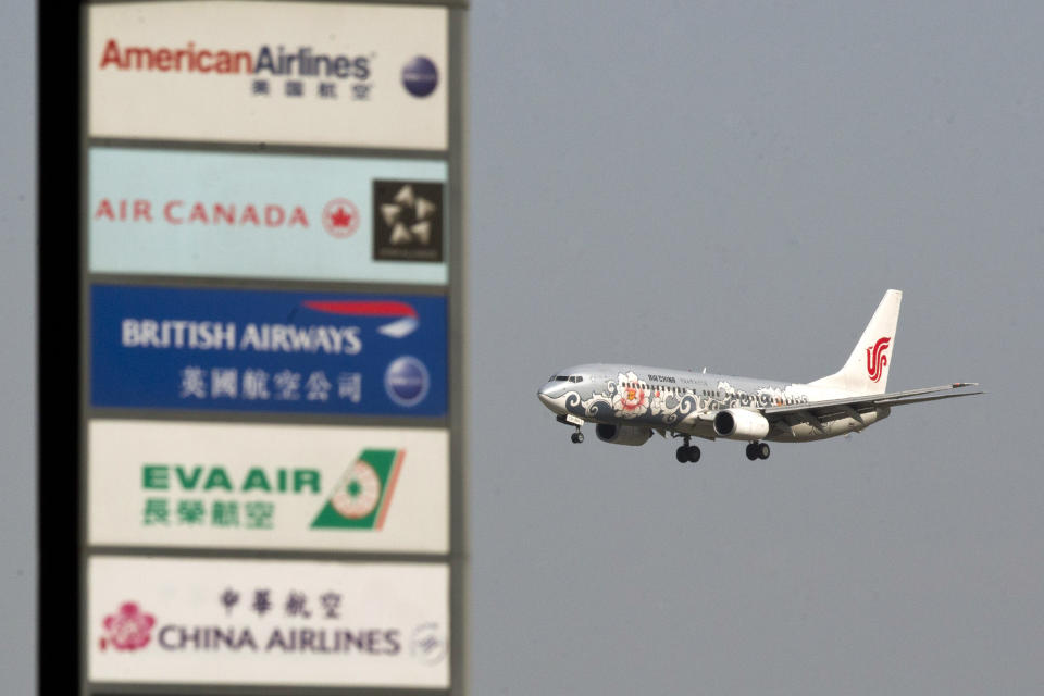 FILE - In this Wednesday, May 23, 2012 file photo, an Air China jet prepares to land at the Capital International Airport in Beijing. Flying this summer doesn’t need to be expensive, as search engines, social media, creativity and flexibility can make finding bargain airfares easier. (AP Photo/Alexander F. Yuan, File)