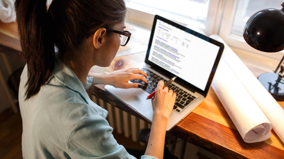 Young female blogger working at home.