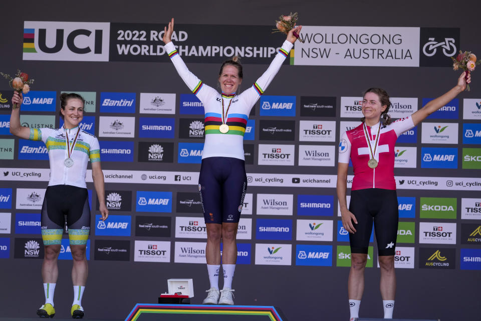 CORRECTS SPELLING OF SURNAME: Ellen van Dijk of the Netherlands, centre, reacts on the podium after winning the women's individual time trial at the world road cycling championships in Wollongong, Australia, Sunday, Sept. 18, 2022. Grace Brown, left, of Australia, was second and Switzerland's Marlen Reusser, right, was third. (AP Photo/Rick Rycroft)