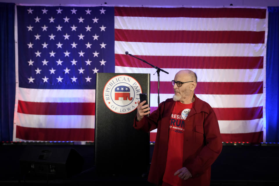 Gene Reasoner of Des Moines, Iowa, takes a selfie during a Republican Party of Iowa election-night rally, Tuesday, Nov. 8, 2022, in Des Moines, Iowa. (AP Photo/Charlie Neibergall)