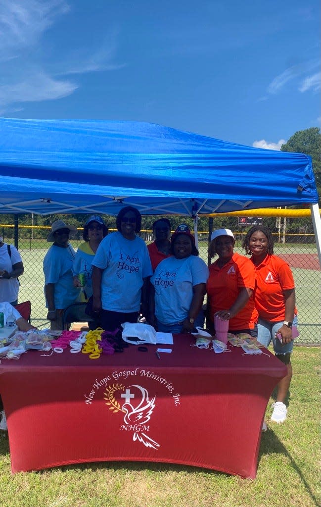 Volunteers gather at the Massey Hill Fun Day at Massey Hill Recreation Center on Saturday.