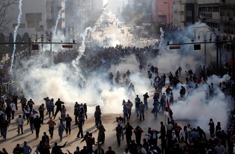 FILE PHOTO: Protesters flee from tear gas fire during clashes in Cairo,