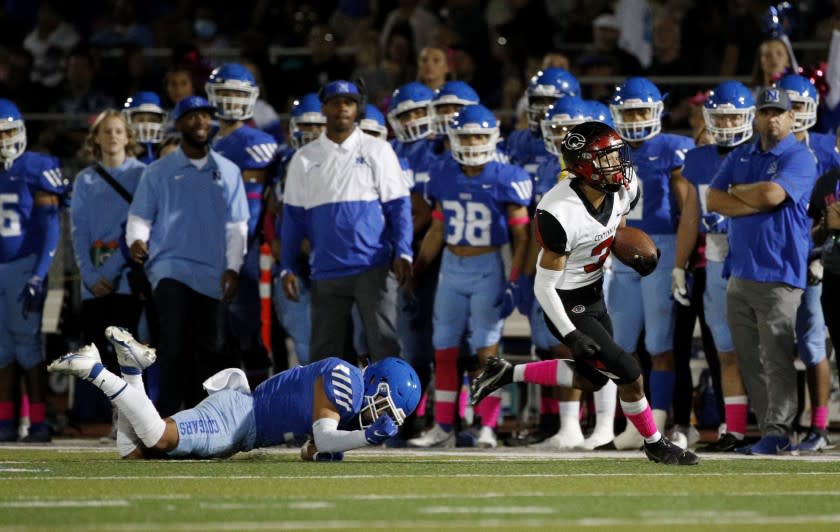 NORCO, CA - OCTOBER 15, 2021: Corona Centennial wide receiver Nathan Jimenez (3) finds open field after a missed tackle by Norco defensive back Issac Mendoza (3) and reaches the end zone to score during the first half at Norco High School on October 15, 2021 in Norco, California.(Gina Ferazzi / Los Angeles Times)