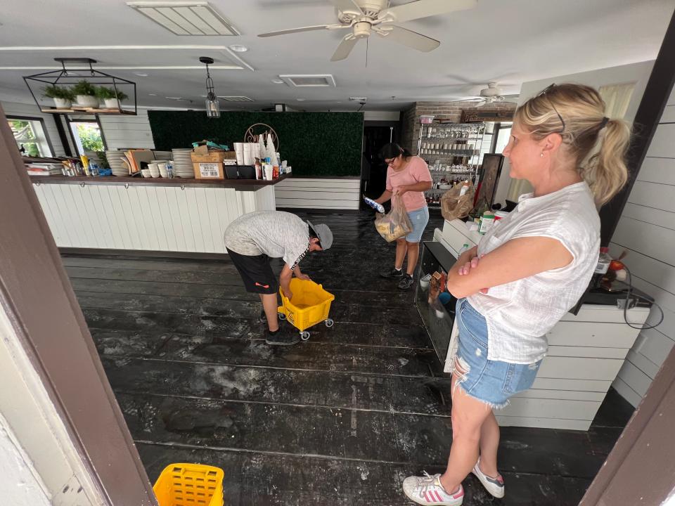 Martina Smith, right, takes stock in how Hurricane Ian's storm surge impacted her Marco Island businesses, including here at Smith House Restaurant & Tavern, on Oct. 1.