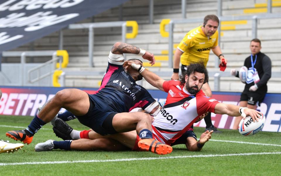 Rhys Williams of Salford Red Devils scores a try against Hull FC - GETTY IMAGES