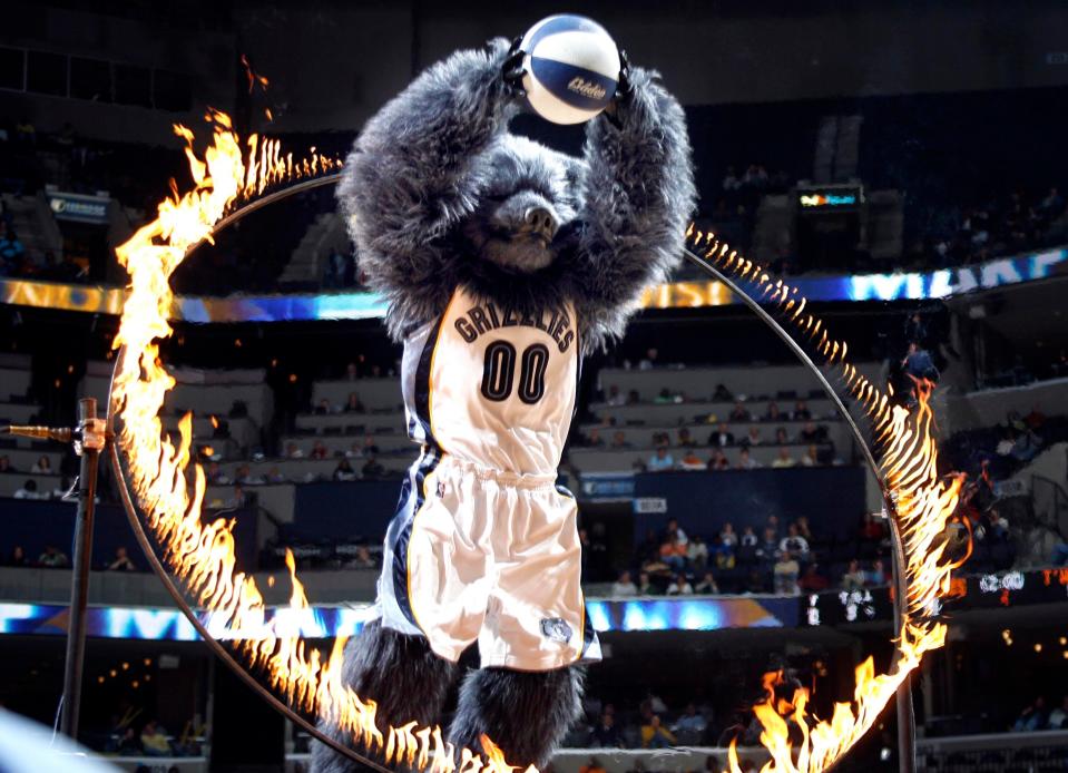 Memphis Grizzlies mascot Grizz leaps through a ring of fire before dunking the ball at a Dec. 1, 2007, game at FedExForum.
