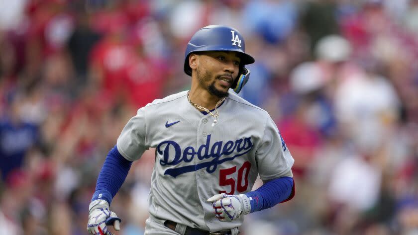 Los Angeles Dodgers' Mookie Betts (50) hits a solo home run during a baseball game.