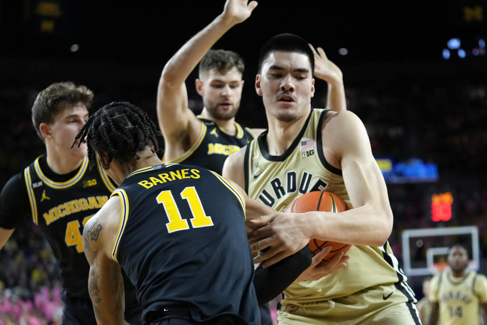 Purdue center Zach Edey fights for a loose ball with Michigan guard Isaiah Barnes (11) during the first half of an NCAA college basketball game in Ann Arbor, Mich., Thursday, Jan. 26, 2023. (AP Photo/Paul Sancya)