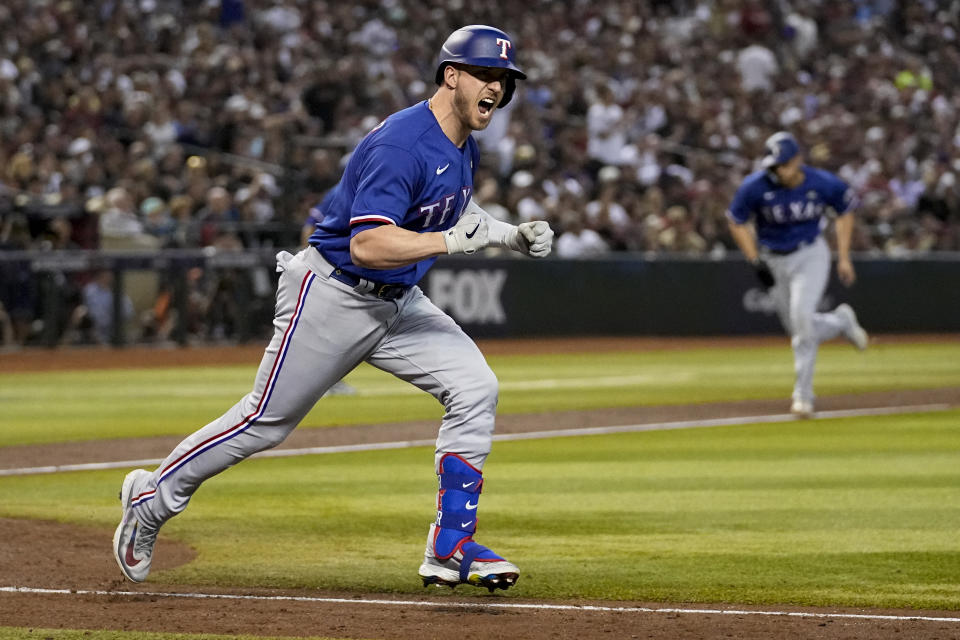 Texas Rangers' Mitch Garver celebrates after a RBI single against the Arizona Diamondbacks during the seventh inning in Game 5 of the baseball World Series Wednesday, Nov. 1, 2023, in Phoenix. (AP Photo/Brynn Anderson)