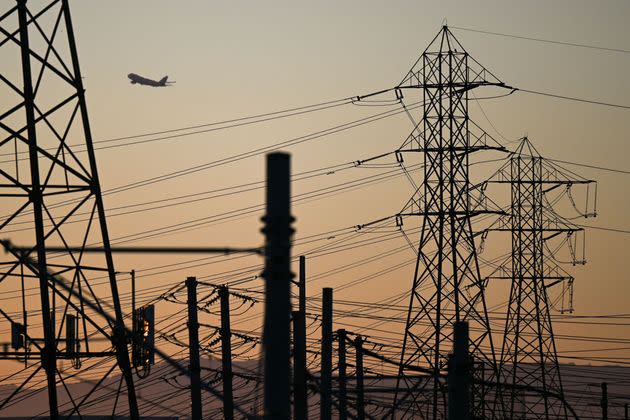 A plane is seen taking off behind power lines in El Segundo, California, as authorities urged energy conservation across the state on Wednesday, Aug. 31. (Photo: PATRICK T. FALLON/AFP via Getty Images)