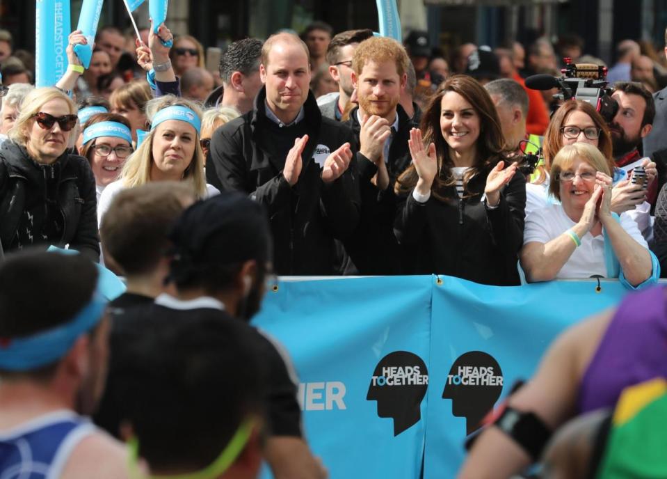 Huge support: Kate, William and Harry cheer on runners (PA)