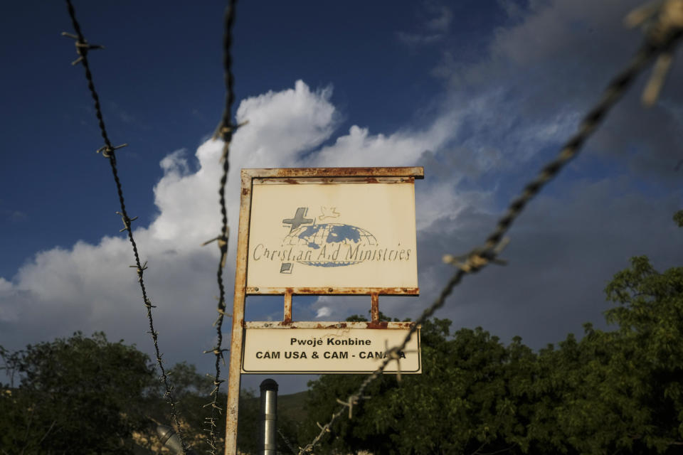 FILE - This Oct. 21, 2021, photo shows a sign outside Christian Aid Ministries in Titanyen, Haiti, which had 17 of their members kidnapped by the 400 Mawozo gang. Catholic priest Jean-Nicaisse Milien was kidnapped for 20 days along with other priests, nuns, and civilians in April by same gang. (AP Photo/Matias Delacroix, File)