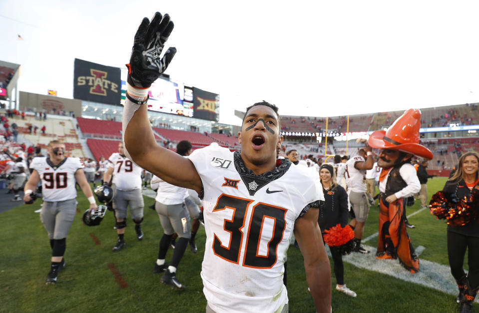 FILE - In this Oct. 26, 2019, file photo, Oklahoma State running back Chuba Hubbard blows a kiss to Oklahoma State fans after their 34-27 win over Iowa State in an NCAA college football game in Ames, Iowa. After the Power Five conference commissioners met Sunday, Aug. 9, 2020, to discuss mounting concern about whether a college football season can be played in a pandemic, players took to social media to urge leaders to let them play. (AP Photo/Matthew Putney, File)