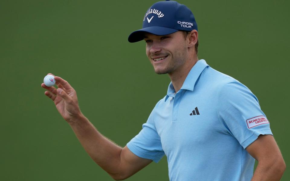 Nicolai Hojgaard, of Denmark, waves after making a putt on the second hole during the first round at the Masters golf tournament