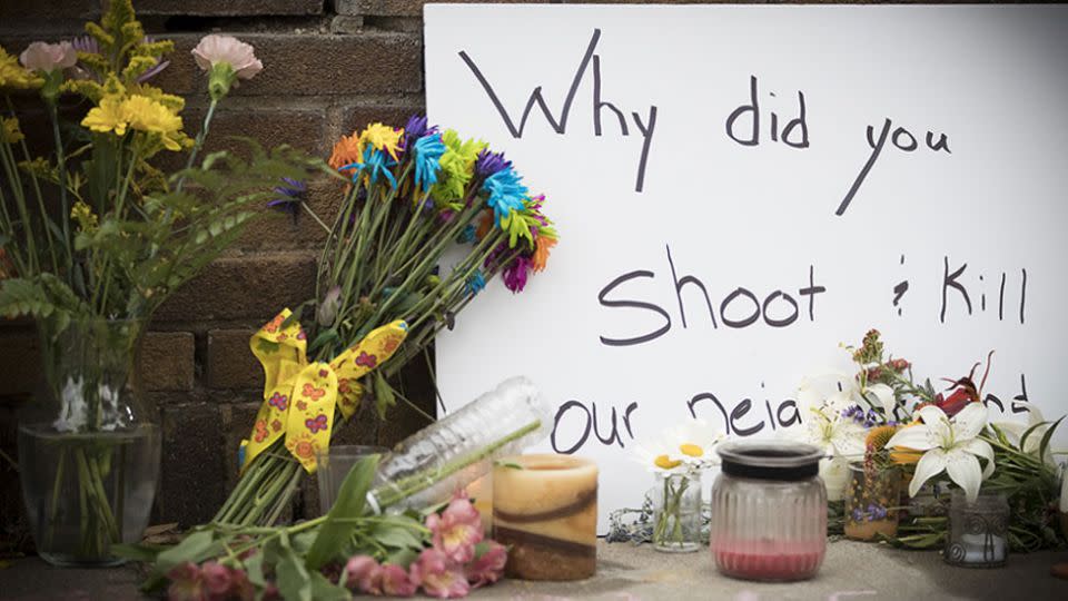 A memorial to Ms Ruszczyk Damond includes a sign demanding to know why she was shot. Photo: AAP