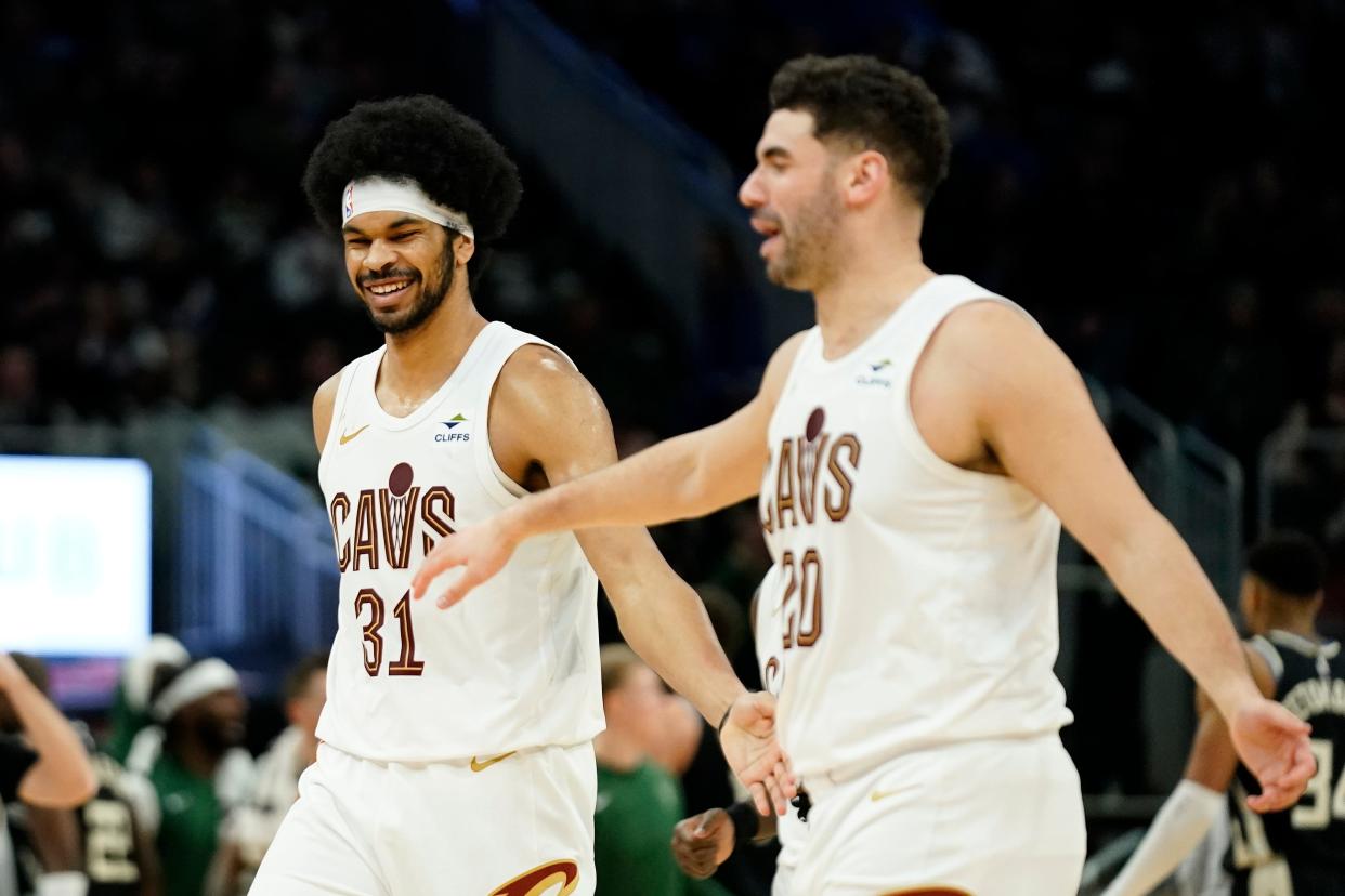 Cleveland Cavaliers' Jarrett Allen (31) smiles with Georges Niang (20) during the second half of an NBA basketball game against the Milwaukee Bucks, Friday, Jan. 26, 2024, in Milwaukee. (AP Photo/Aaron Gash)